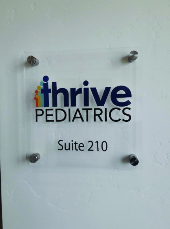 Thrive Pediatrics plexiglass signage