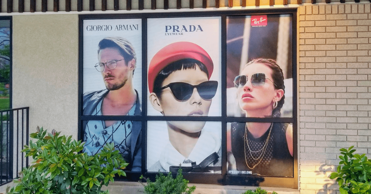 Window Perf design featuring luxury eyewear brands Giorgio Armani, Prada Eyewear, and Ray-Ban, installed on storefront windows at Clarifeye in Kuna.